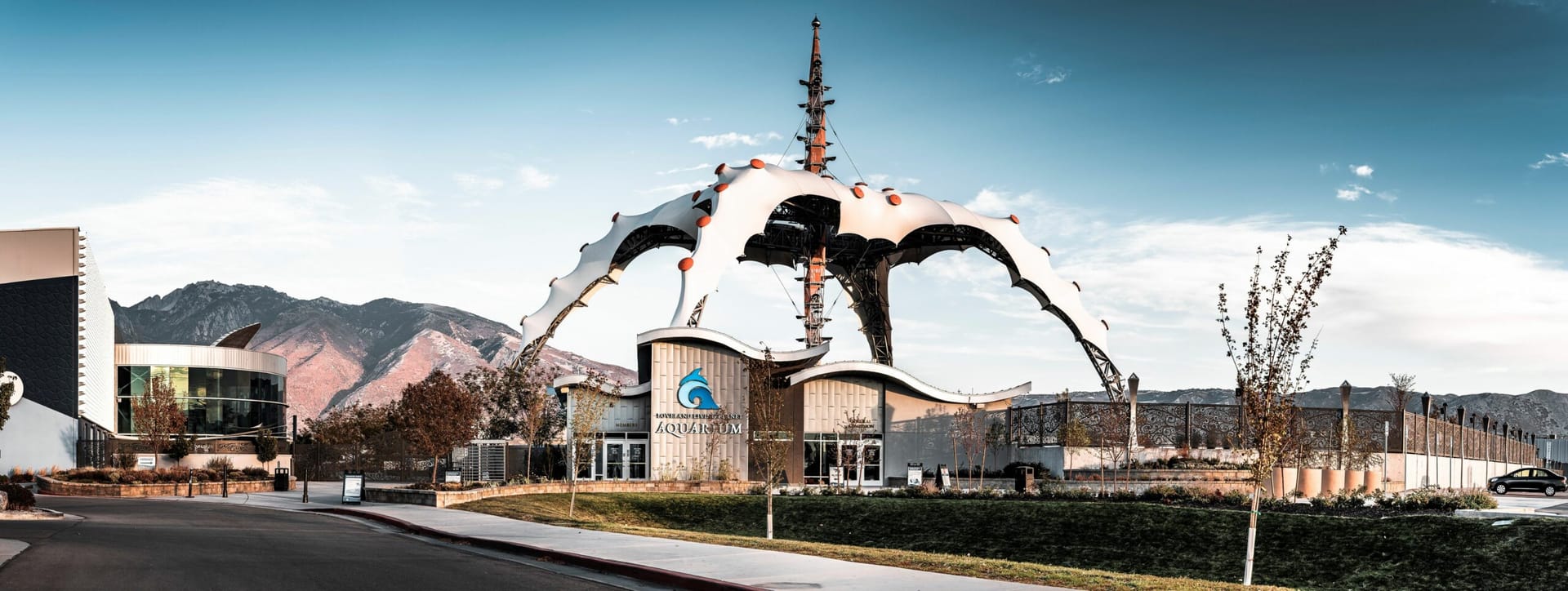 The sculptural steel canopy over the new entrance at the Loveland Living Planet Aquarium, framed by the Wasatch mountains