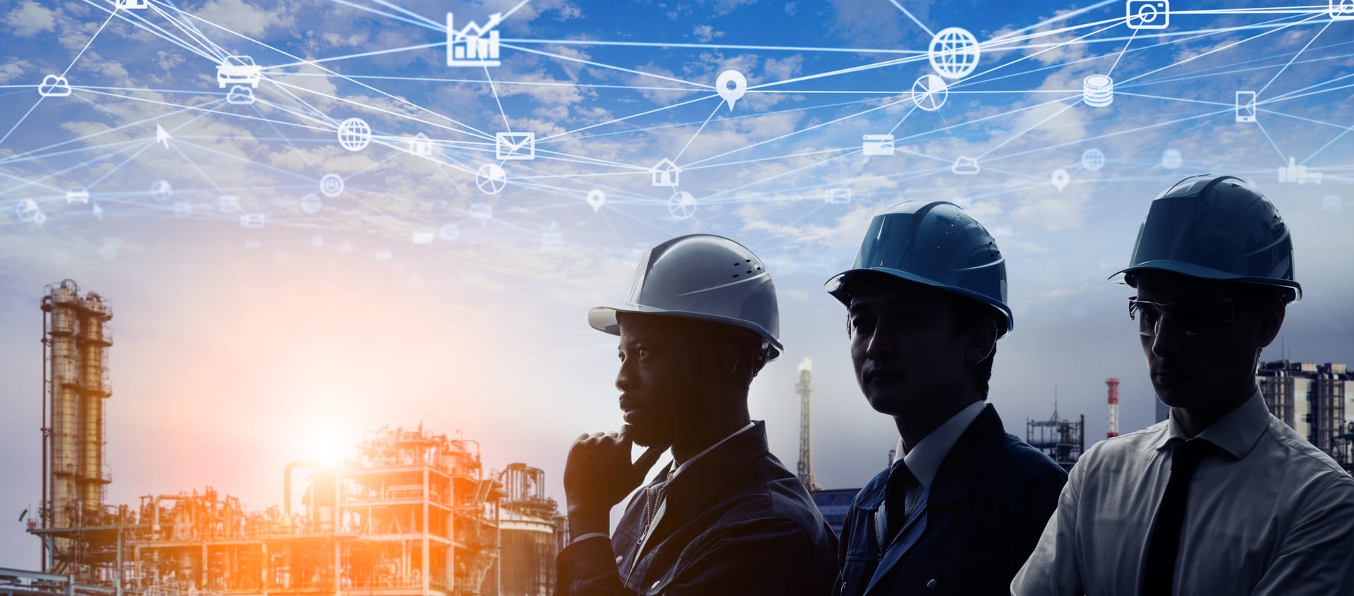 Three hard-hatted project managers looking out over an active industrial facility at sunrise, a web of linked planning icons overlaid on the sky